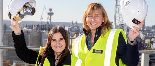 Two female construction workers smiling