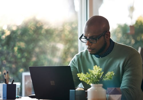 Man working on Microsoft laptop