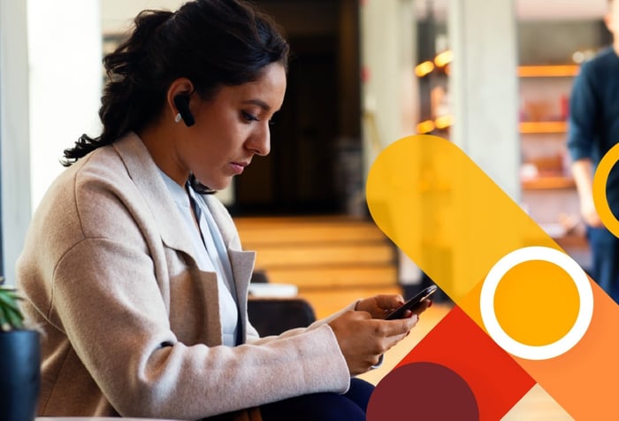 Woman looking at her phone with Viva Connections logo on top of image