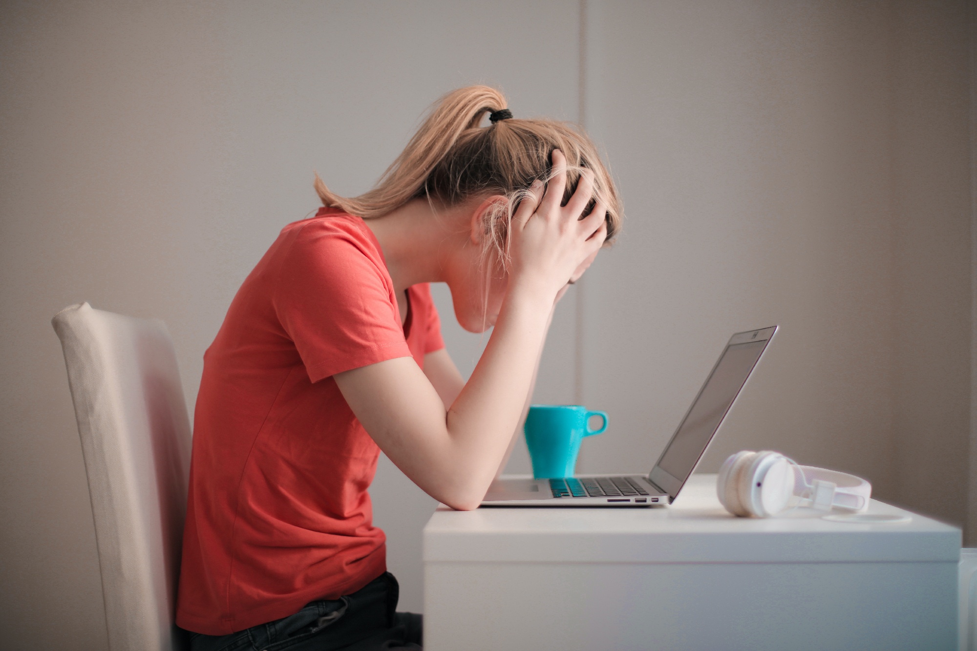 Woman with hands in her hair looking frustrated