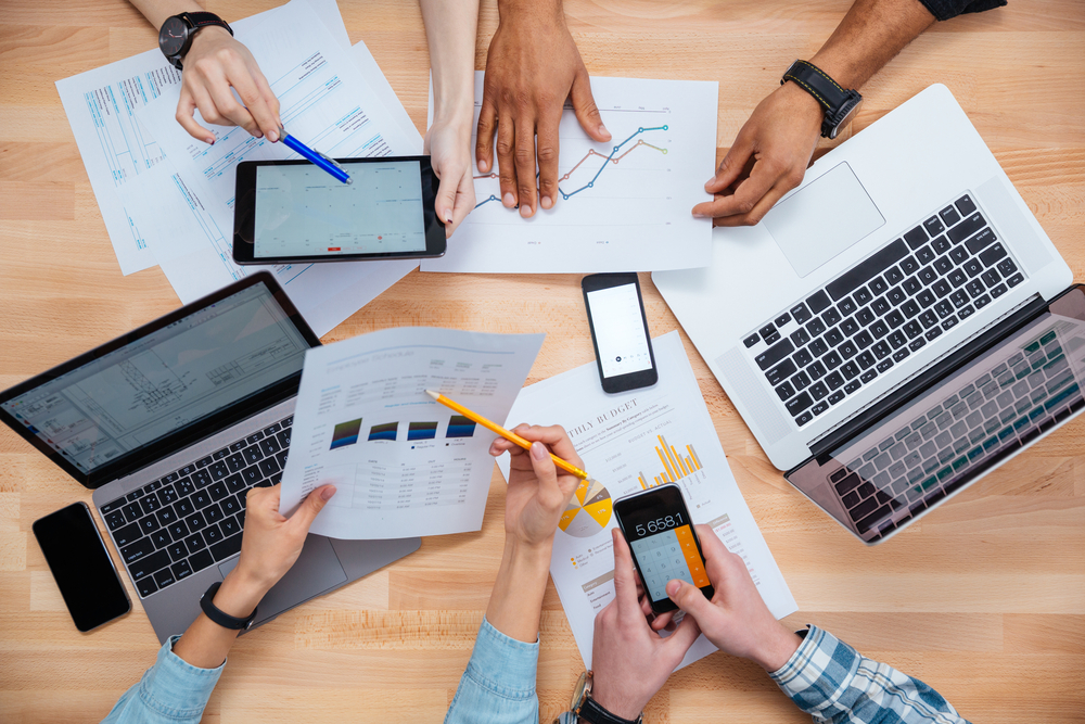 Business people using mobile phones and laptops